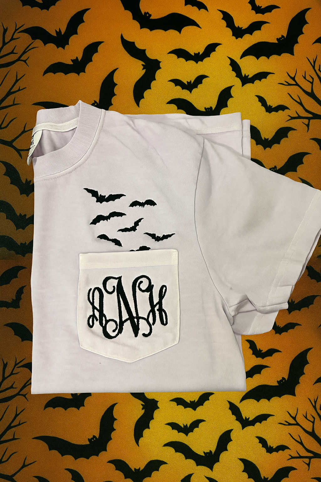 Embroidered monogram bat pocket tee